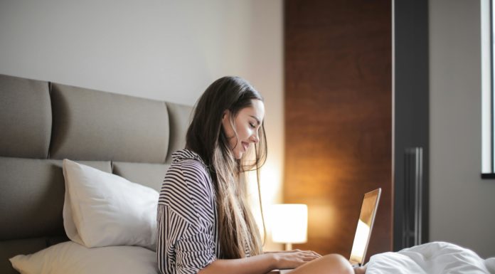 Foto von Andrea Piacquadio: https://www.pexels.com/de-de/foto/seitenansicht-foto-der-lachelnden-frau-in-einem-schwarz-weiss-gestreiften-oberteil-das-auf-einem-bett-sitzt-wahrend-man-einen-laptop-benutzt-3765035/